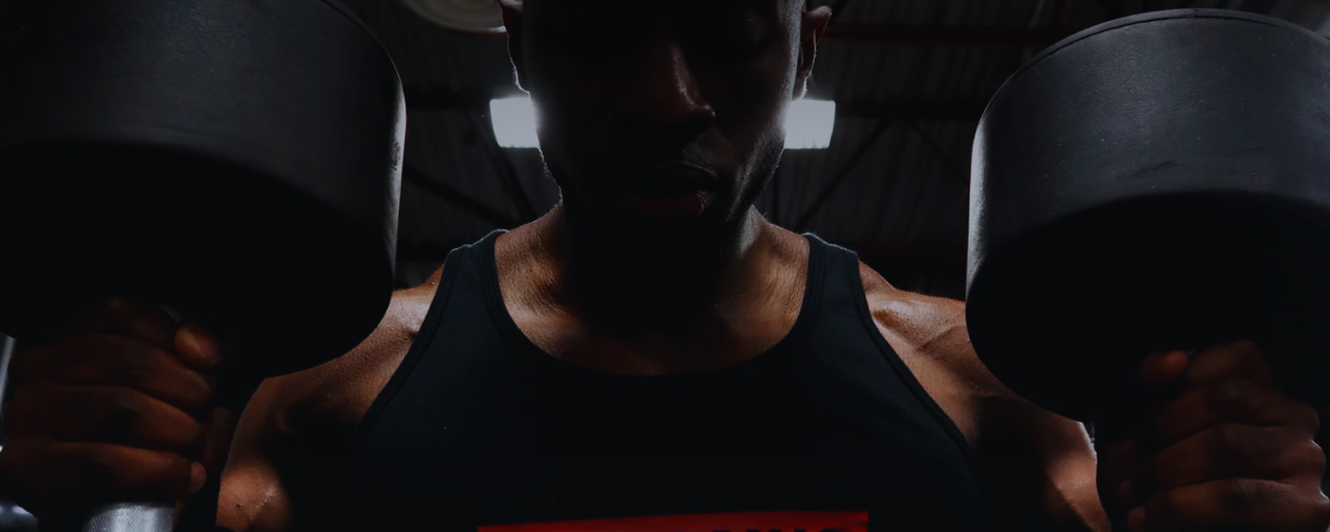 Person lifting a barbell in a gym setting